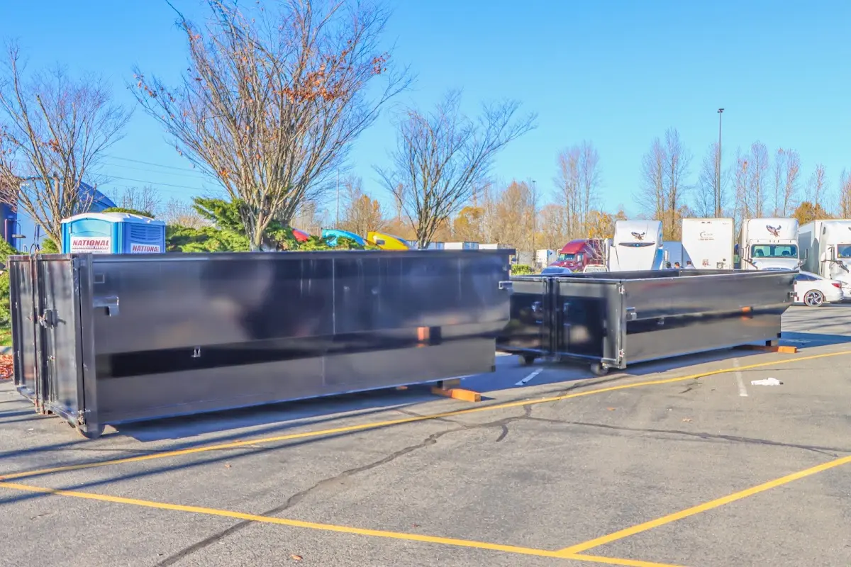 Professional dumpster rental service with roll-off container on residential driveway in Clifton Park